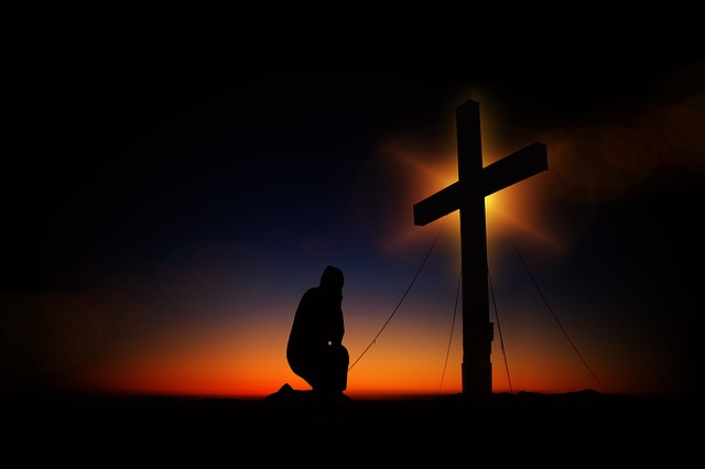 Kneeling before the cross